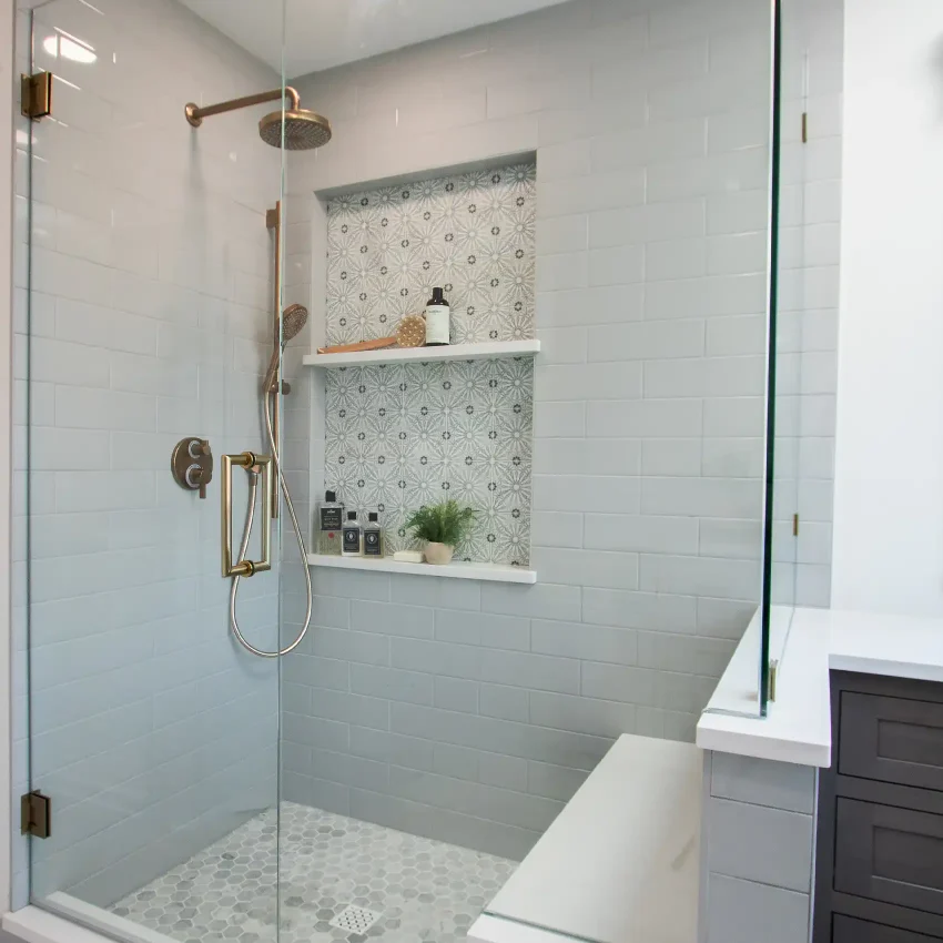Bathroom with a brass rainfall showerhead, subway tile and glass enclosure