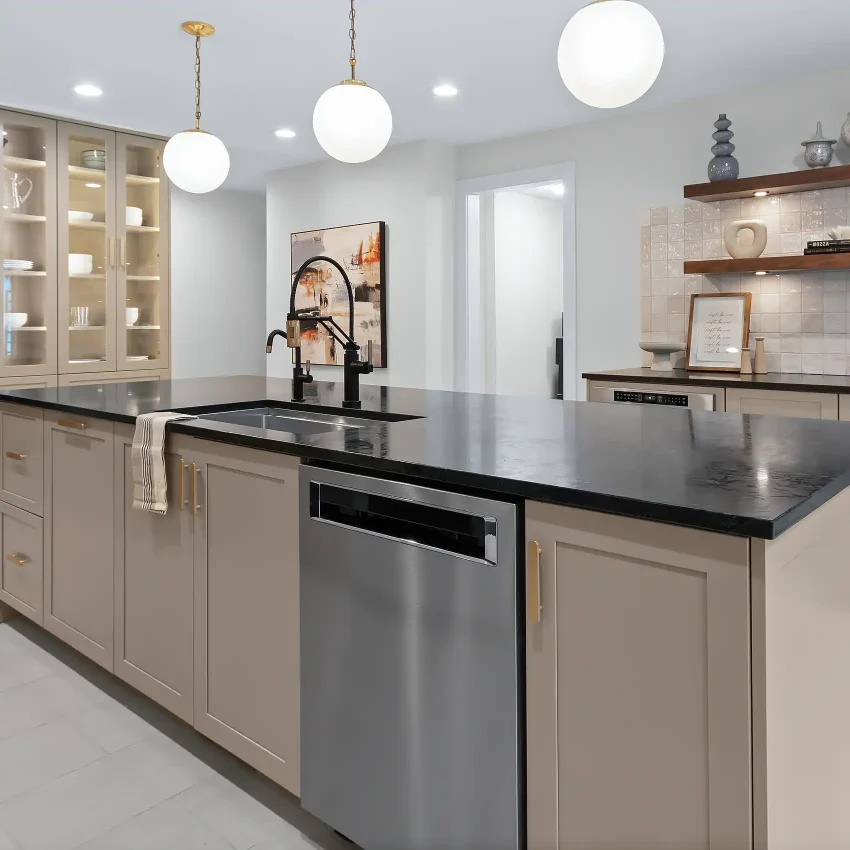 Cream shaker kitchen cabinets with a black countertop and brass pendant lights