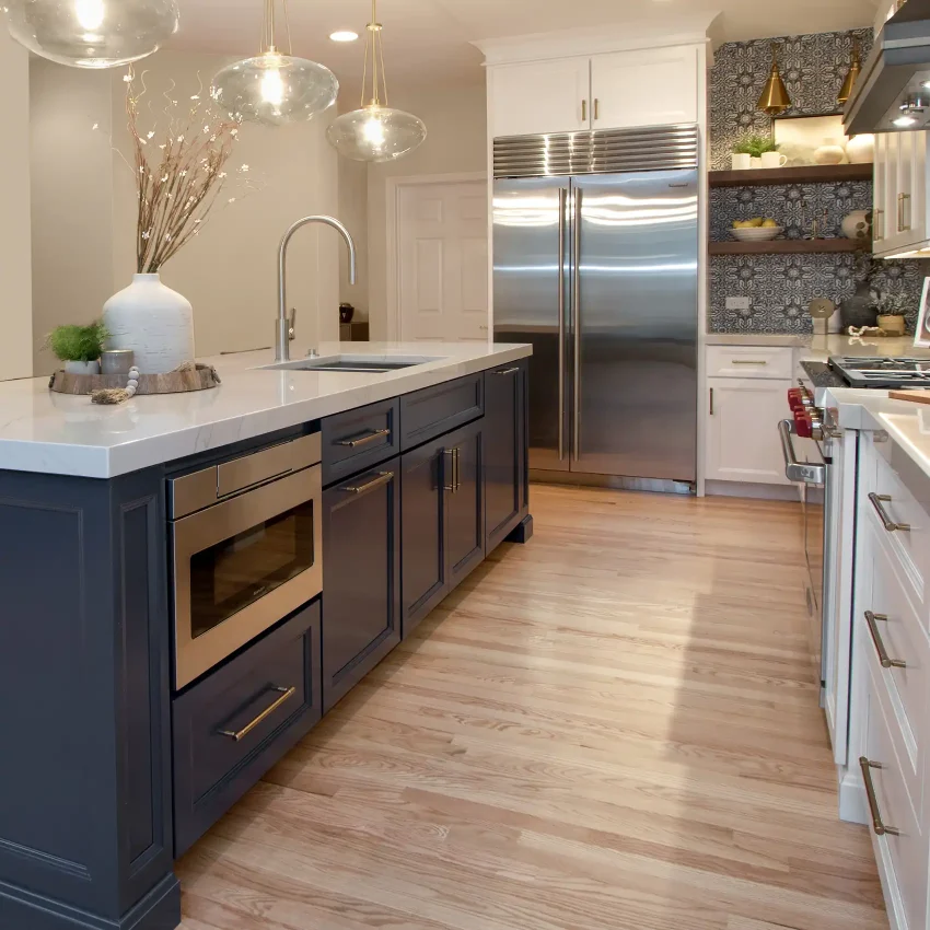 White kitchen cabinets with a dark navy island and open shelving