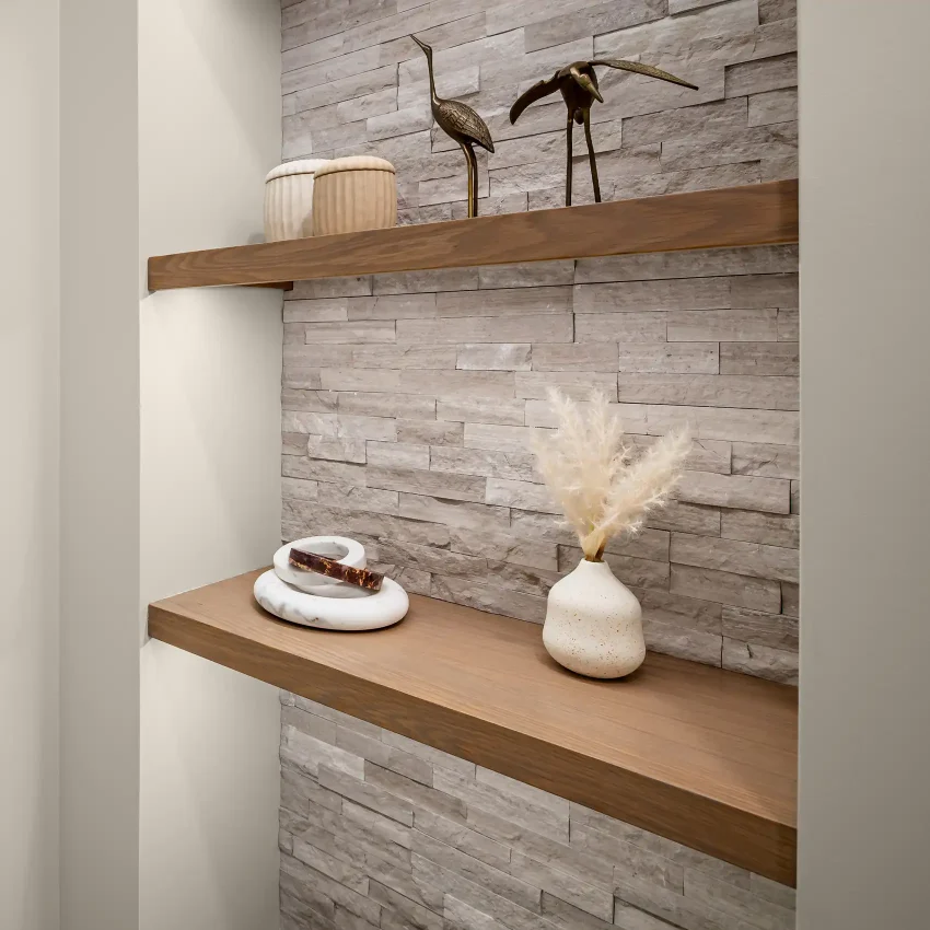 Bathroom with gray shiplap walls and a wood shelf