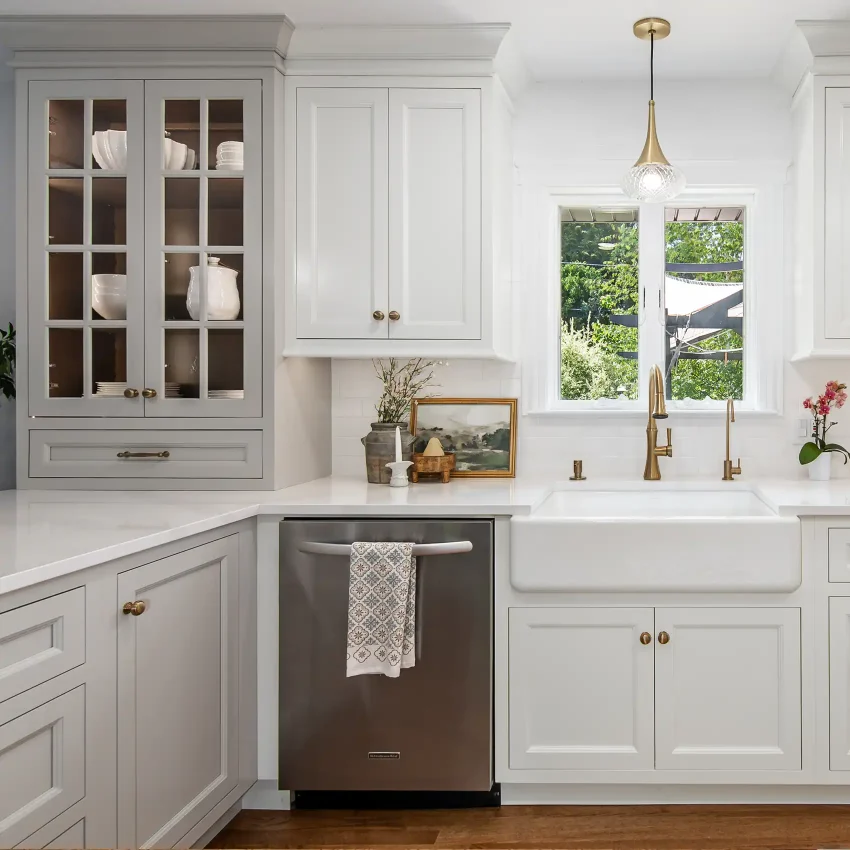 Two-tone gray and white kitchen cabinets with a geometric backsplash