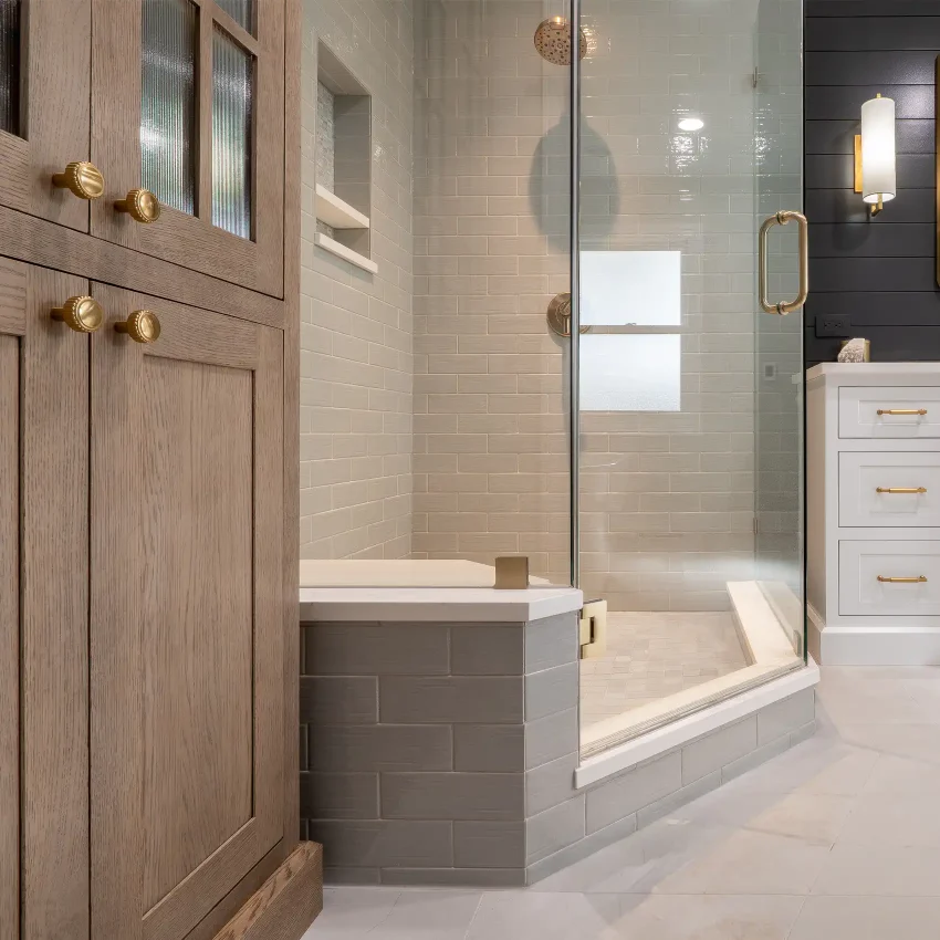 Bathroom with a walk-in glass shower and subway tile